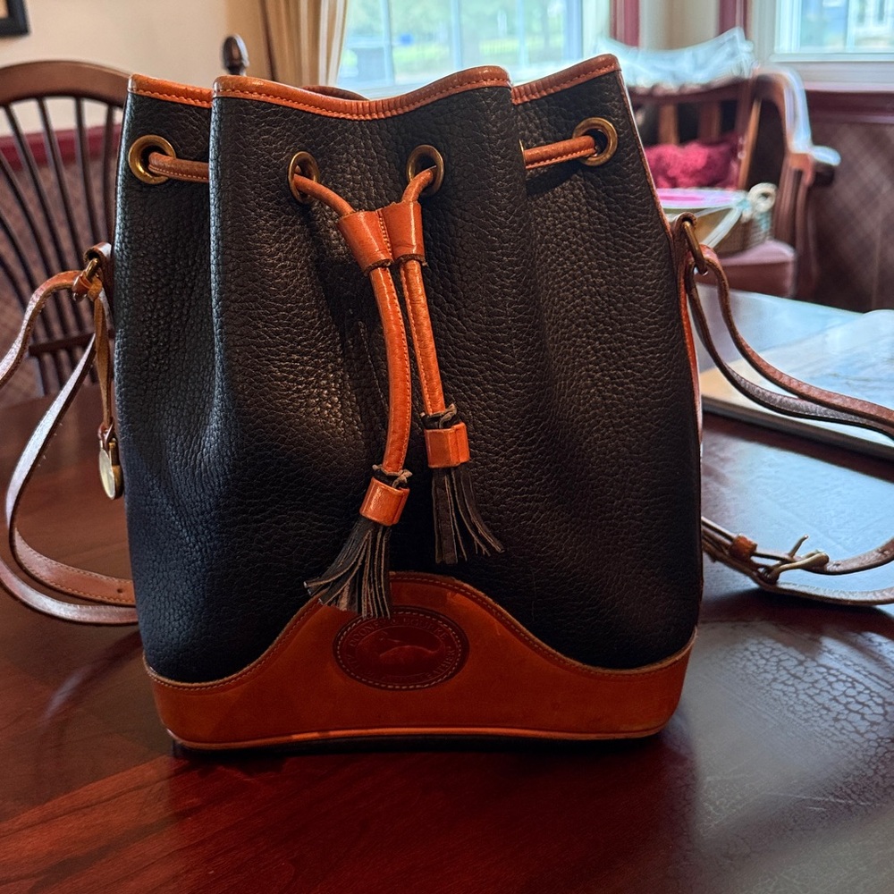 Dooney & Burke black and brown leather bucket bag.